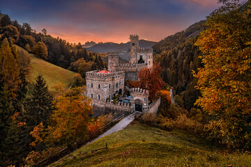 Wall Mural - Latzfons, Italy - Beautiful autumn scenery at Gernstein Castle (Castello di Gernstein, Schloss Gernstein) at sunrise in South Tyrol with colorful sky and golden foliage with Dolomites at background