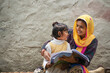 © IndiaPix - happy indian mother and daughter, mother helping her daughter in study