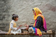 © IndiaPix - indian mother and daughter, mother helping her daughter in study