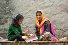 Happy Indian Mother And Daughter, Mother Helping Her Daughter In Study