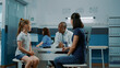© DC Studio - Physician greeting little girl and mother in medical cabinet. Male doctor and patient having conversation about disease and prescription treatment at annual checkup visit. Health service