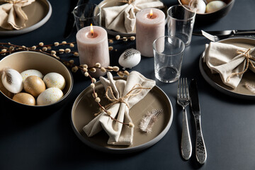 Wall Mural - easter, holidays, tradition and object concept - close up of dinner party table serving over black background