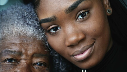 Wall Mural - Generational women portrait faces a grandmother and granddaughter posing for camera together