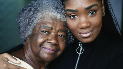 Wall Mural - Generational women portrait faces a grandmother and granddaughter posing for camera together