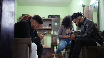 Candid group of friends staring at phones living in isolation bubbles