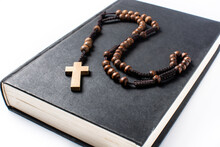 Rosary Catholic Cross On Holy Bible Isolated On White Background	