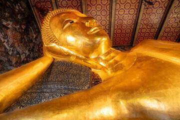 Wall Mural - Giant golden reclining Buddha statue at Wat Pho Temple in Bangkok