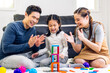 © Art_Photo - Portrait of enjoy happy love asian family father and mother with little asian girl smiling activity learn and skill brain training play with toy build wooden blocks board education game at home