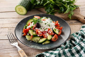 Poster - Traditional Bulgarian shopska salad with tomato,cucumber and bulgarian sirene cheese on wooden table	