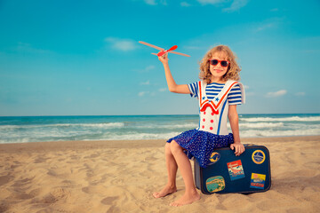 Canvas Print - Happy child playing with toy airplane