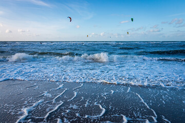 Wall Mural - North Sea beach with surf, waves and kitesurfer