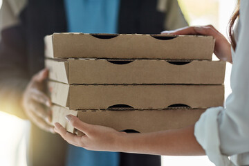 Sticker - Baked fresh, delivered fast. Cropped shot of a man making a pizza delivery to a customer.