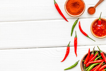 Wall Mural - Cooking hot food with chilli pepper on white wooden table background top view copy space