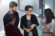 © Mikolette M/peopleimages.com - Making progress on their new project. Shot of a group of businesspeople having a discussion in an office.