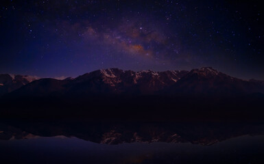 Wall Mural - Landscape with Milky Way. Night sky with stars on the mountain