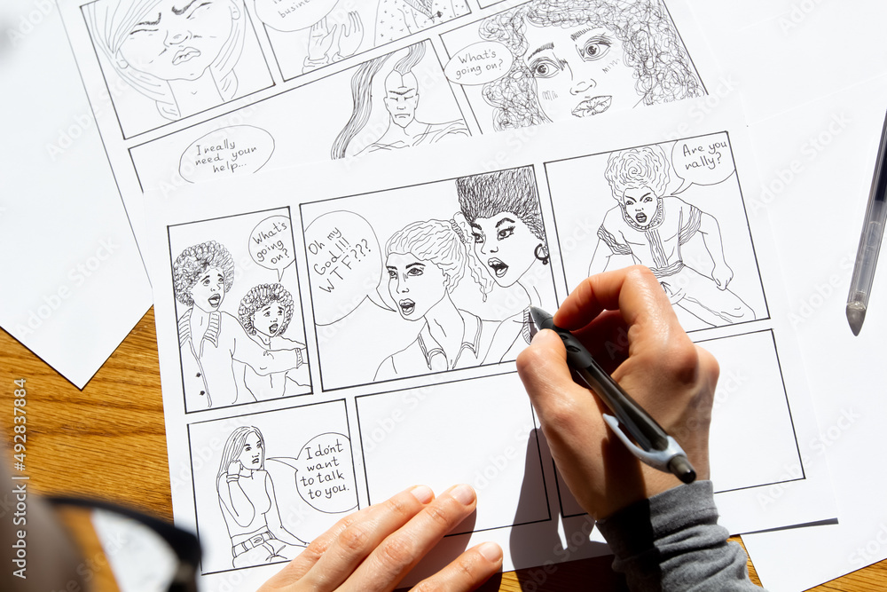 The artist draws a storyboard of comic book characters on sheets