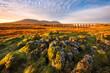 Beautiful scenic view with golden morning light at Ribblehead Viaduct in The Yorkshire Dales National Park, UK.