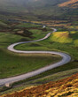 © _Danoz - Long winding curved road leading through British valley below Mam Tor in the Peak District. Conceptual landscape backgrounds.