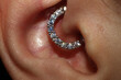 Girl ear piercing. Macro.
Daith piercing + cubic zirconia clicker.