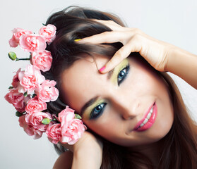 Beauty young real woman with pink flowers and make up closeup, spa salon, womans day concept