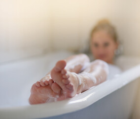 Wall Mural - Let all your worries just drift away. Shot of a beautiful young woman relaxing in the bathtub.