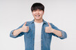 Happy young asian korean boy man student showing thumbs up, saying yes, agrees, smiling with braces isolated in white background