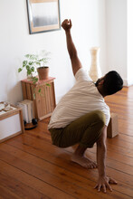 Anonymous Man Practicing Acro Yoga In His Living Room