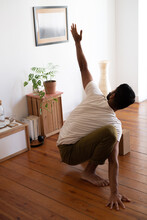 Anonymous Man Practicing Acro Yoga In His Living Room