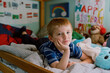 © Francesca Russell/Stocksy - A little boy lies in his bed.