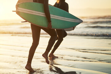 Canvas Print - Life is an adventure, live it. Shot of an unrecognizable young couple going surfing at the beach.