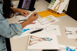 © Valentina Barreto/Stocksy - Fashion designer drawing on desk