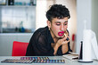 © Ana Luz Crespi/Stocksy - Latino non binary doing club kid make up
