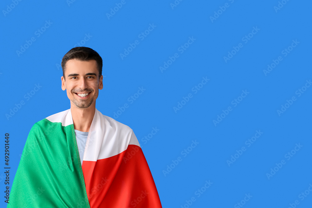 Young man with Italian flag on color background