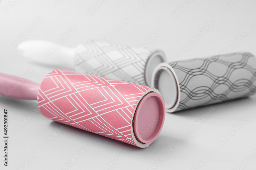 New lint rollers on light background, closeup