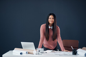 Success is earned, never handed out. Portrait of an attractive young female architect working in her office.