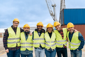 Multiracial worker people having fun inside container cargo terminal at maritime port - Main focus on indian man face