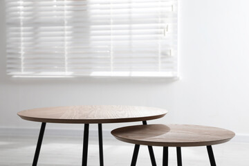 Empty wooden nesting tables indoors. Stylish furniture