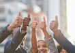 © Delcio F/peopleimages.com - Our optimism is unbeatable. Shot of a group of businesspeople giving the thumbs up.