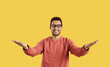 You did it. Congratulations. Happy cheerful positive young ethnic man in eyeglasses standing against yellow color background looking at camera, smiling and spreading his arms wide open for a warm hug