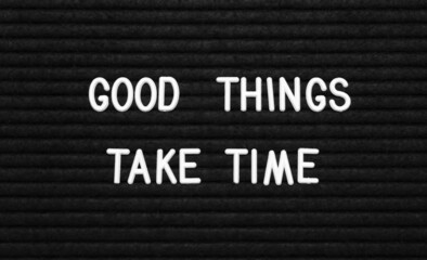 Wall Mural - Black letter board with motivational quote Good Things Take Time, closeup view