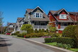 © Alex Lyubar - Residential District in Richmond City, a village of townhouses , green grass bushes and trees in the territory of residential complex, blue sky, Vanсouver, British Columbia