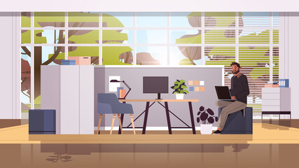 Wall Mural - businessman working on laptop business man freelancer using notebook at workplace modern office interior