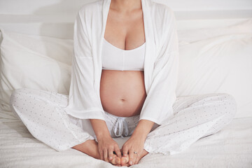 Wall Mural - Baby on board. Cropped shot of a pregnant woman at home.