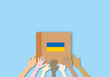 Group of volunteers united diversity unity holding boxes for the needs of Ukrainian migrants, Humanitarian aid concept, space for the text, paper cut design style.