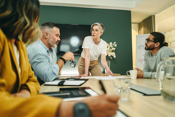 Business manager leading a meeting with her team in a boardroom