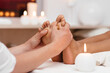 Perfect clean female foot . Beautiful and elegant groomed girl's hand touches her feet . Spa ,scrub and leg care .