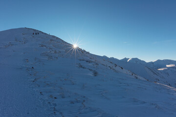 Wall Mural - beautiful winter views of the high tatra mountains with tourists, skiers and amazing states of natur