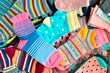 Bright colored socks. Lots of different socks create the backdrop. Knitwear in the form of socks.