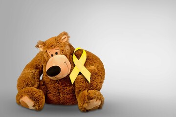 Canvas Print - International Childhood Cancer Awareness month, Children toy with golden Ribbon for supporting