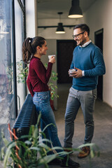 Wall Mural - Side view of people, drinking coffee during a break from work.